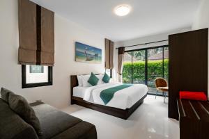 a bedroom with a bed and a couch at Baan Piengfah Holiday Home Ao Nang in Ao Nang Beach