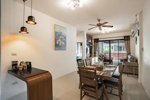 a dining room and living room with a table and chairs at Baan Piengfah Holiday Home Ao Nang in Ao Nang Beach