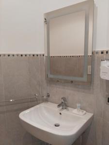 a white sink in a bathroom with a mirror at Villa Belvedere Salento in Porto Cesareo