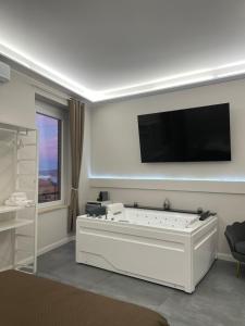 a living room with a tv and a pool table at Le Cisterne Guest house Suite&Rooms in Vasto