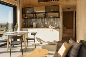 a kitchen and living room with a table and chairs at Hvile, gmina Brenna - BESKIDY in Górki Wielkie