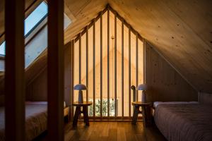 a room with two beds and a large window at Hvile, gmina Brenna - BESKIDY in Górki Wielkie