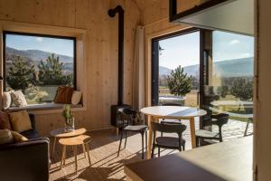 a room with a table and chairs and windows at Hvile, gmina Brenna - BESKIDY in Górki Wielkie