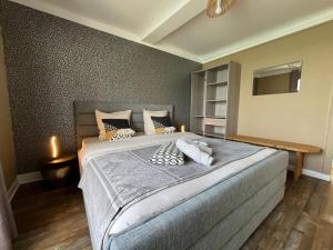 a bedroom with a large bed with pillows on it at Le Phoenix 449 , vue mer, 2 chambres in Arromanches-les-Bains