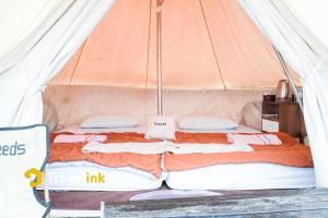 a bed in a tent with two pillows at Sun CampGround in Kejajar +9 photos