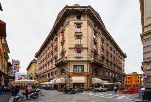 a tall building on a city street with motorcycles in front at Casa Lusso con 3 Camere con Affaccio Esclusivo su San Petronio in Bologna