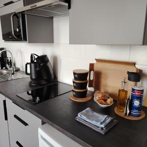 a kitchen with a black counter top with a coffee maker at Chez Adèle in Le Mont Saint Michel