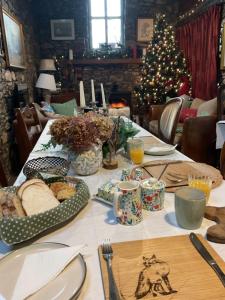 a table with food and a christmas tree in a room at Fennor Park Lodge in Oldcastle