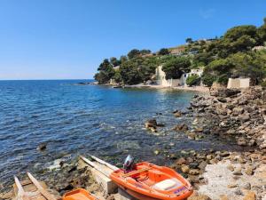 an orange boat on the shore of a beach at Chez Tao in Carqueiranne