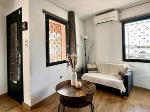 a living room with a table and a chair at Chez Tao in Carqueiranne