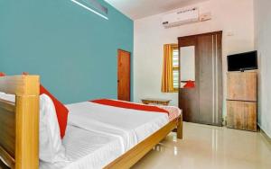 a bedroom with a bed and a television in it at Thottunkal Tourist home in Kadavoor