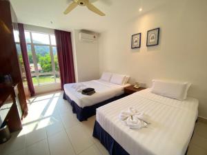 Postel nebo postele na pokoji v ubytování Mak Sa'adiah Hotel