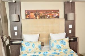 a bedroom with a bed and a painting on the wall at RAMATA GUEST HOUSE in Pretoria +116 photos