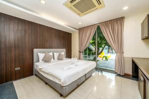 a bedroom with a large bed and a large window at Villa Navin Beach Residence in Jomtien Beach +267 photos