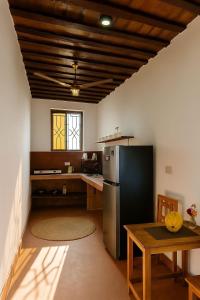 a kitchen with a black refrigerator and a table at Villa Katerina - Paje in Paje