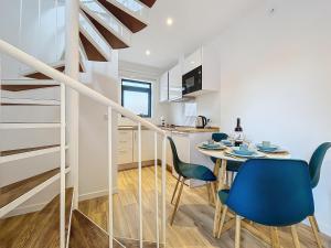 a kitchen and dining room with a table and chairs at Avo Maria 2 House by AH in Senhora do Rosário