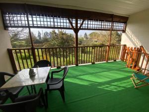 a room with a balcony with a table and chairs at Ancienne ferme Rougerie in Montech