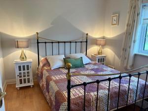 a bedroom with a bed with two lamps on two tables at 3 bedroom home close to Athenry in Galway in Athenry