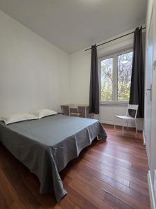 a bedroom with a bed and a large window at Budget Hôtel Weber - Strasbourg Centre Gare in Strasbourg