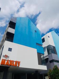 a building with a meway sign on the side of it at Behomy Maxley Lippo Karawaci in Tangerang