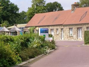 a brick building with a sign in front of it at ZEcamping 4 étoiles familial avec étang de pêche et piscine chauffée in La Haye-du-Puits