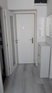 ein leeres Zimmer mit einer weißen Tür und einem Schrank in der Unterkunft Apartmán Convent in Saar