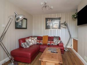 a living room with a red couch and two lamps at The Lily Pad in Chester