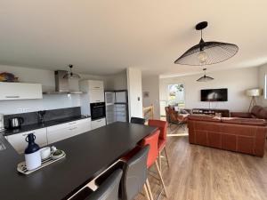 a kitchen and living room with a black counter top at Armor in Trébeurden