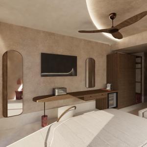 ein Schlafzimmer mit einem Bett und einem Fernseher an der Wand in der Unterkunft Stella Maria in Malia