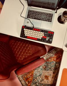 a laptop computer sitting on top of a table with a keyboard at Alter Space Workspace and CoLiving in General Luna