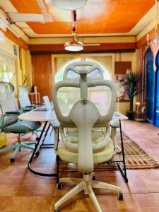 a chair in a room with tables and chairs at Alter Space Workspace and CoLiving in General Luna