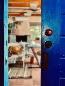 a blue door with a red button in a room at Alter Space Workspace and CoLiving in General Luna +7 photos