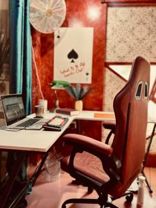 an office with a desk with a chair and a laptop at Alter Space Workspace and CoLiving in General Luna
