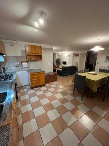 a kitchen and living room with a table and a couch at Casa Cortese in Gallio