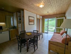 a living room with a table and a dining room at VVF Sud Aveyron in Brusque