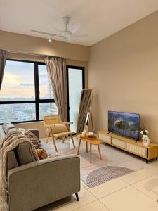 a living room with a couch and a flat screen tv at Southplace Tropicana Metropark by HostInn in Subang Jaya