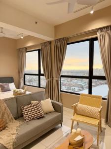 a living room with a couch and a bed at Southplace Tropicana Metropark by HostInn in Subang Jaya +25 photos