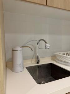a kitchen counter with a sink and a appliance at Southplace Tropicana Metropark by HostInn in Subang Jaya