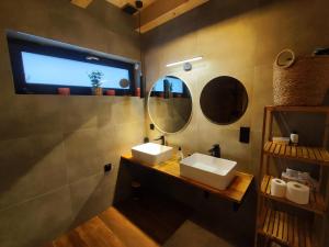 a bathroom with two sinks and a mirror at Villa Panorama in Żywiec