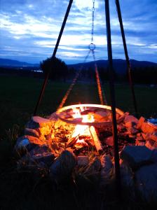 a fire pit in a field at night at Villa Panorama in Żywiec