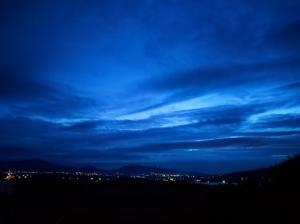 a blue sky with clouds above a city at night at Villa Panorama in Żywiec +42 photos