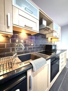 a kitchen with a sink and a counter top at Maggie's Lodge in Leeds
