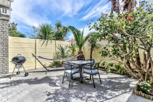 布鲁堡史特兰Modern Duplex Fully Air-Conditioned near Beach的天井配有吊床和桌椅 更多20张照片