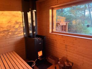 a woodburning stove in a room with a window at Landbahnhof Buschhof 1 OG, mit Gartensauna in Buschhof