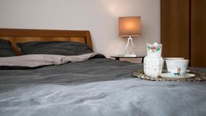 a bed with a table with a vase and two cups at Villa Gemma in Alba