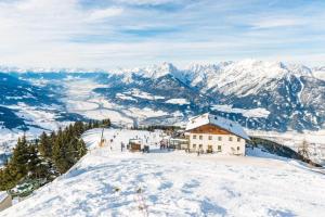 a building on the top of a snow covered mountain at Hecherhaus in Schwaz