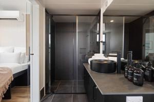 a bathroom with a sink and a bed at Grevillea Villa in Valdora