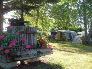 a park with a fountain and flowers and tents at ZEcamping 4 étoiles dog friendly bar piscine couverte in Faverolles-sur-Cher