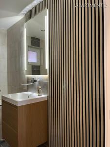 a bathroom with a sink and a mirror at 5 min to Airport Gate 25 - Free Parking -Easy Check-in in Ledine +10 photos