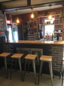 a bar with four stools in a restaurant at ZEcamping 3 étoiles animé animaux acceptés familial piscine couverte in Avrillé